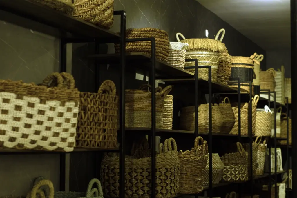 Shelves filled with various handcrafted woven baskets in different shapes and patterns, displayed for wholesale in Indonesia