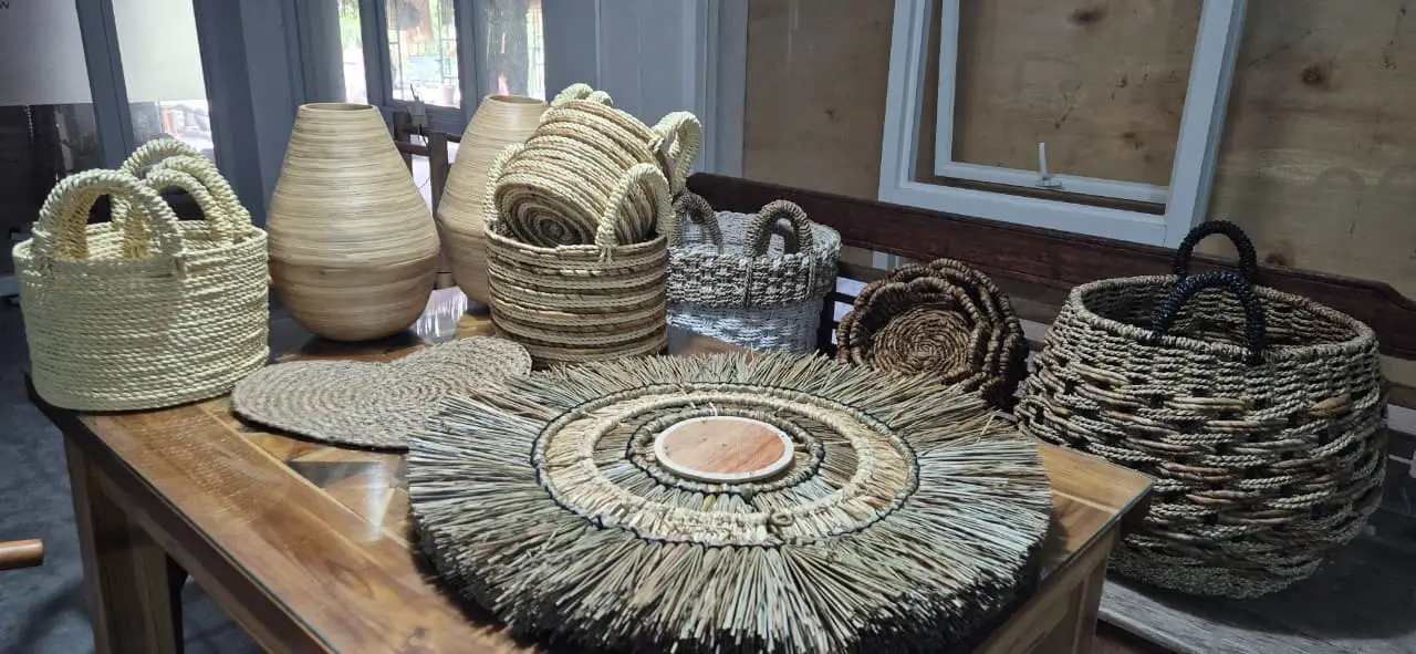 A collection of handcrafted items from a rattan basket factory Indonesia, including natural laundry baskets and wholesale seagrass baskets.